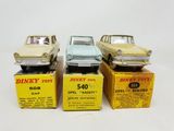 three dinky toy cars are sitting on top of boxes