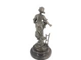statue of a woman sitting on a chair holding a basket