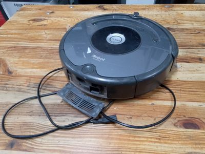 an image of a robotic vacuum cleaner on a wooden table
