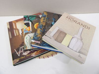several books are stacked on top of each other on a table