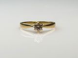 a close up of a diamond ring on a white surface
