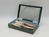 a green box with three different types of knives in it