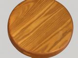 a close up of a wooden stool with a wooden seat