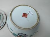 a small bowl with a lid and a small bowl with a lid on a table