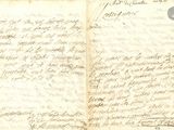 an old book with writing on it sitting on top of a table