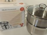 une casserole en acier inoxydable et une boîte posées sur la table