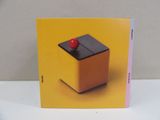 a yellow box with a red apple on top of it