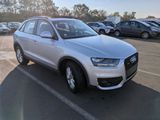 the white audi suv is parked in the parking lot