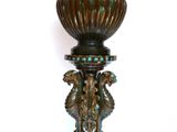a vase that is sitting on a stand on a white surface