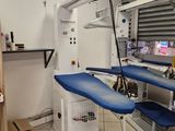 a blue ironing board sitting on a table in a room