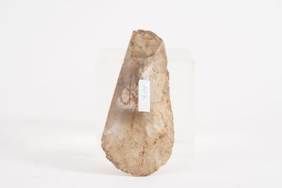 a rock with a tag on it sitting on a white surface