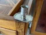 a wooden table with a metal candle holder on top of it