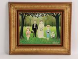 tableau encadré représentant un portrait de famille dans un parc, avec une mariée, un marié et deux enfants