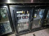 a glass door that has a bunch of bottles inside of it