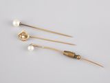 a pair of gold and pearl hair pins