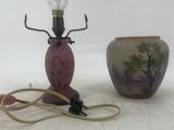 a lamp that is sitting on a table next to a vase