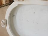a white toilet with the seat up and the lid down