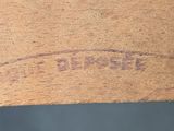 a close up of a piece of wood with a stamp on it
