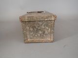 a small metal box with a handle on a table