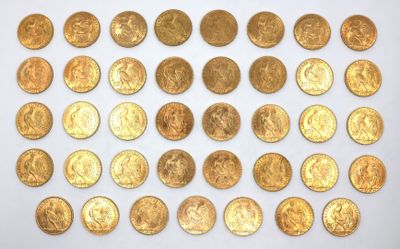 some gold coins are arranged in rows on a white surface