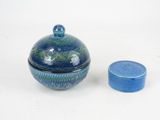 a small blue container with a lid next to a smaller blue container