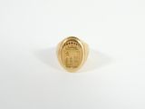 a close up of a gold ring with a coin on it