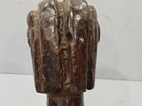 a wooden sculpture of a hand holding a baseball bat