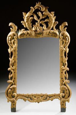 an image of a mirror with a gold frame on a white surface