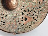 a metal bowl with a decorative design on it