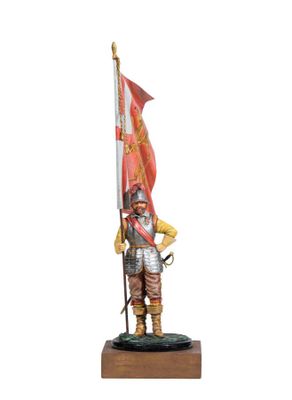 a statue of a man in armor holding a flag on a wooden base