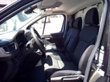 the interior of a car with the door open and the driver ' s seat down