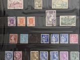 an old picture of a collection of stamps in a display case