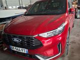 une voiture rouge garée dans un garage à côté d'un bateau
