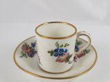 tea cup and saucer decorated with flowers on a white background