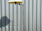 a table with a lamp on it next to a metal wall