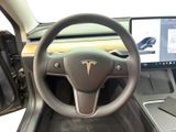 a steering wheel and dashboard of a car with a laptop on it