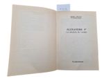 an open book with a piece of paper on top of it