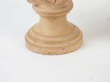 a statue of a woman holding a flower on a pedestal