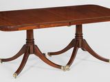 an antique mahogany dining table with four legs and two leaves on each end
