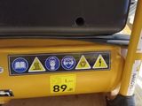 a back end of a yellow construction vehicle with stickers on it