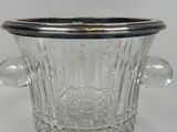 a glass ice bucket with a silver lid on a table