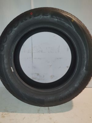 a close up of a tire on a wall near a wall
