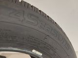 a close up of a tire on a white wall