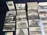 a lot of old postcards of boats on a table