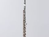 a close up of a flute on a stand on a white surface