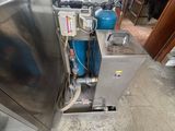 an image of a stainless steel water heater in a garage