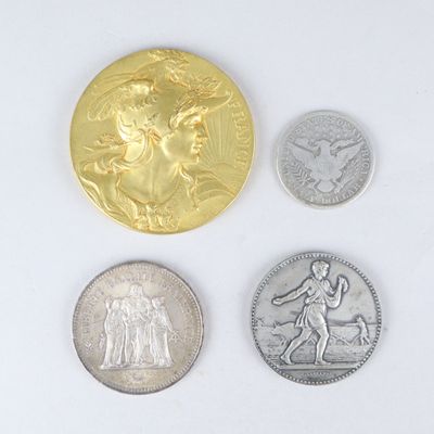 four different types of coins are shown on a white surface