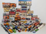 many different types of toy trains and trucks on the table