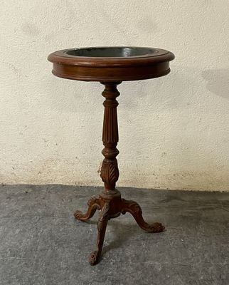 a small wooden table with a bowl on top of it