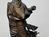 statue of a woman holding a bird on a white background